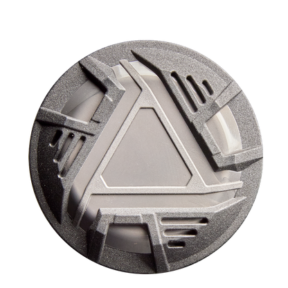 A round, metallic gray object with an angular geometric design rests on a white background, its look inspired by the advanced engineering of the 2026 DeMarini ZEN (-10) USSSA Baseball Bat by DeMarini.