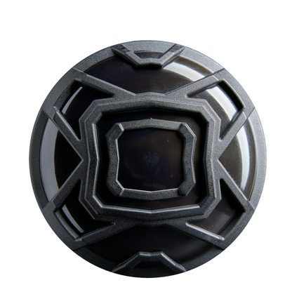 A round, black object with a geometric pattern of raised metallic lines, resembling the 2026 DeMarini The Goods Royal Purple (-3) BBCOR Baseball Bat: WBD2634010 by DeMarini, is seen from above against a white background.