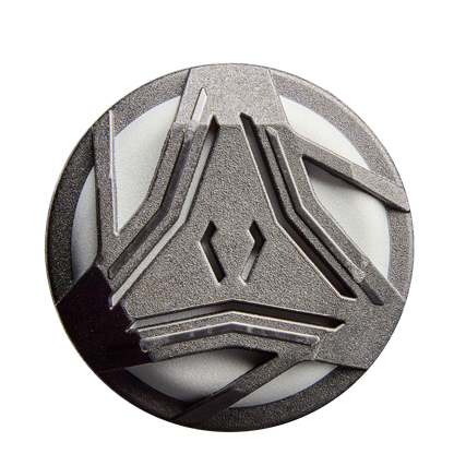 A circular metallic badge with an abstract geometric design of raised angular lines, inspired by the 2026 DeMarini Prism+ (-11) Fastpitch Softball Bat: WBD2636010 from DeMarini, displayed on a white background.