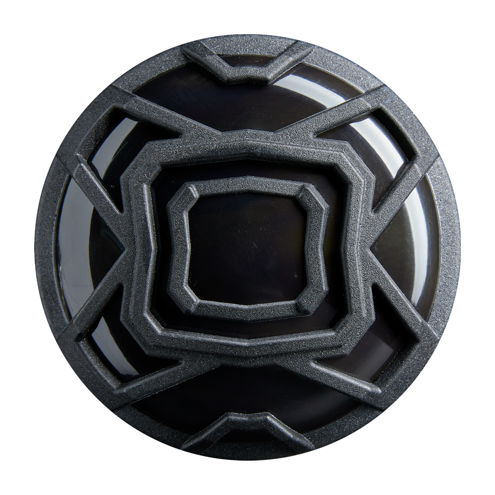 A black circular object with a maze-like, metallic gray pattern, echoing the precision of the DeMarini 2026 The Goods Gunmetal (-3) BBCOR Baseball Bat (WBD2650010), is shown from above on a white background.