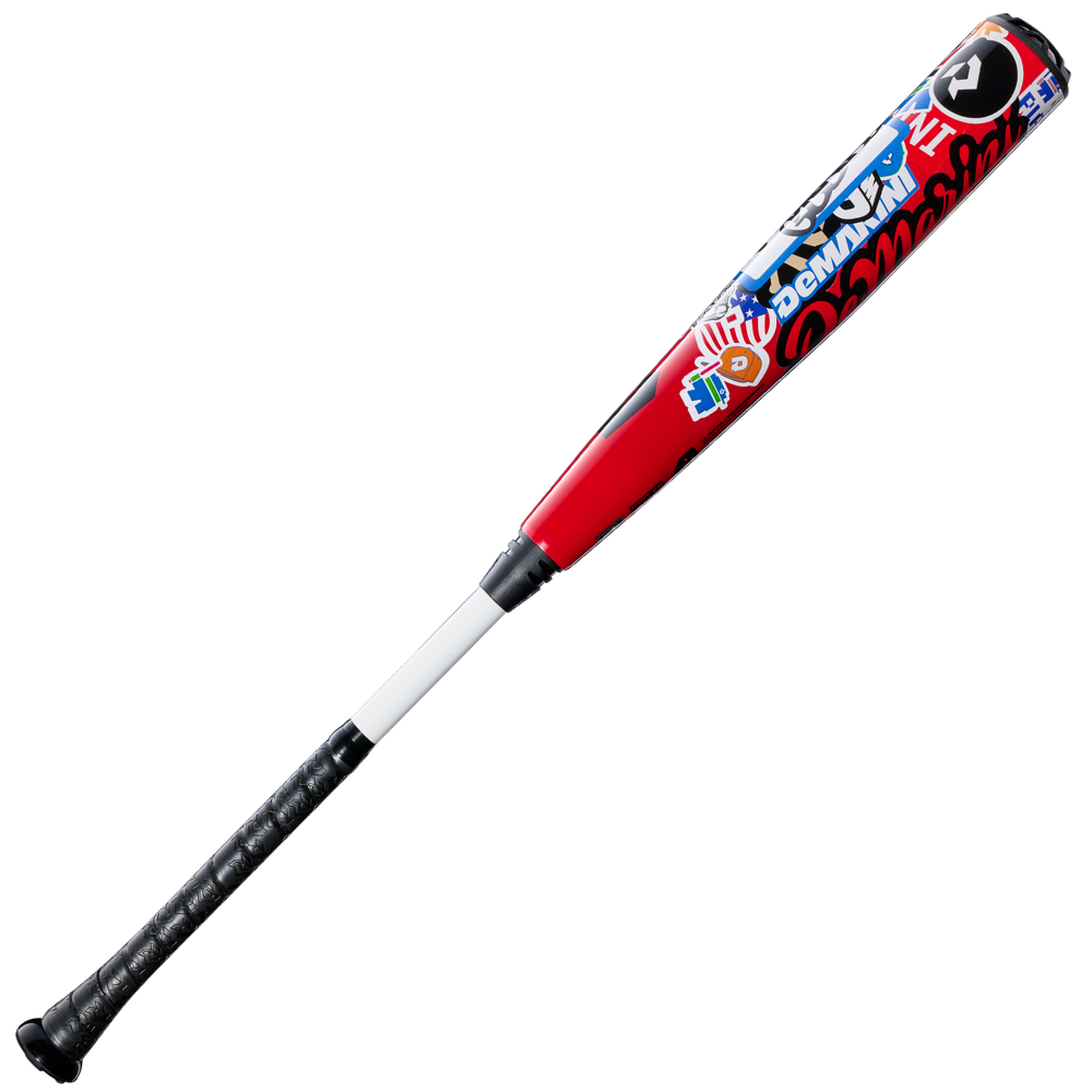 The 2026 DeMarini The Goods Sticker Bomb (-3) BBCOR Baseball Bat (WBD2653010) features a black grip, white handle, and red barrel with vibrant blue, white, and red graphics and text.
