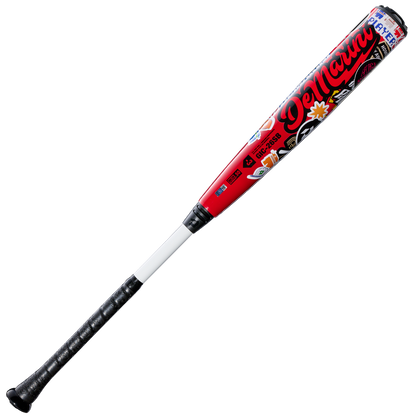 A red and black 2026 DeMarini The Goods Sticker Bomb (-3) BBCOR Baseball Bat (WBD2653010) with a black grip, large DeMarini branding, and colorful graffiti-style sticker bomb designs.