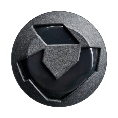 A black, circular object with a geometric, shield-like design—echoing the 2027 DeMarini Juggy Extended 13" Endload USA Slowpitch Softball Bat's barrel—displays three raised sections and a glossy center against a plain white background.