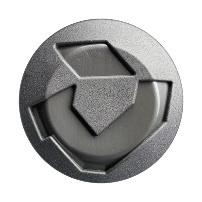 A round, gray plastic camera lens cap with a geometric texture and three triangular grip sections inspired by the grip design of the DeMarini Jason Magnum Vanilla Gorilla 12.5" Endload Softball Bat (WBD2681010).