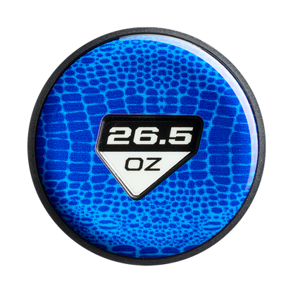 A round, blue object with a textured pattern features "26.5 OZ" in bold white on a black and white shield label, echoing the DeMarini Jeremy Yates Twisted Mistress 13" Endload Slowpitch Softball Bat (WBD2684010) design.