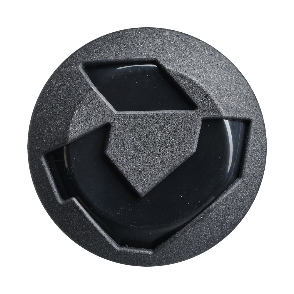 A black, round object with geometric patterns and a glossy center resembles the end cap of the DeMarini 2027 Jeremy Yates Twisted Mistress 13" Endload NSA USSSA Slowpitch Softball Bat (WBD2684010), viewed from above on a white background.