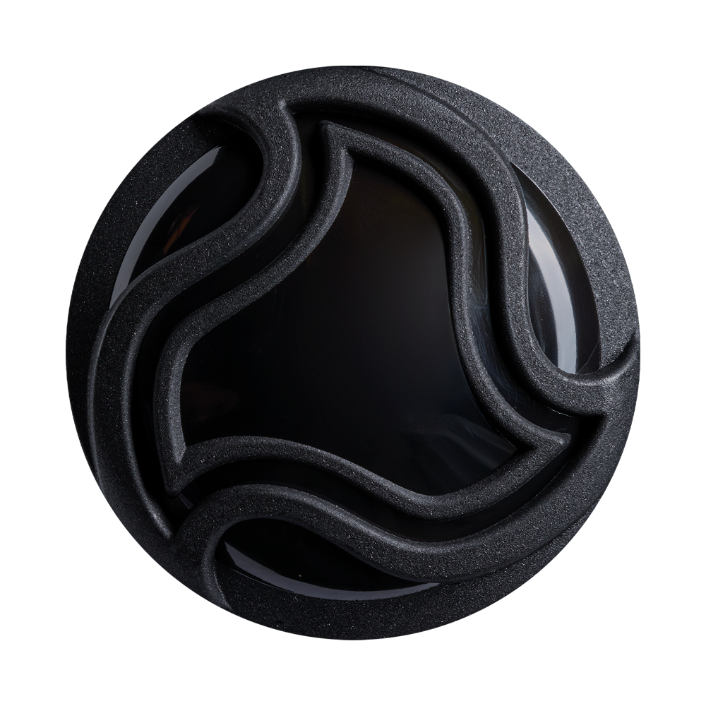 A round, black object with a glossy center and raised, wavy patterns—resembling the intricate design on the DeMarini Exile (-5) 2 3/4" USSSA Baseball Bat (WBD2716010)—is set against a plain light background.
