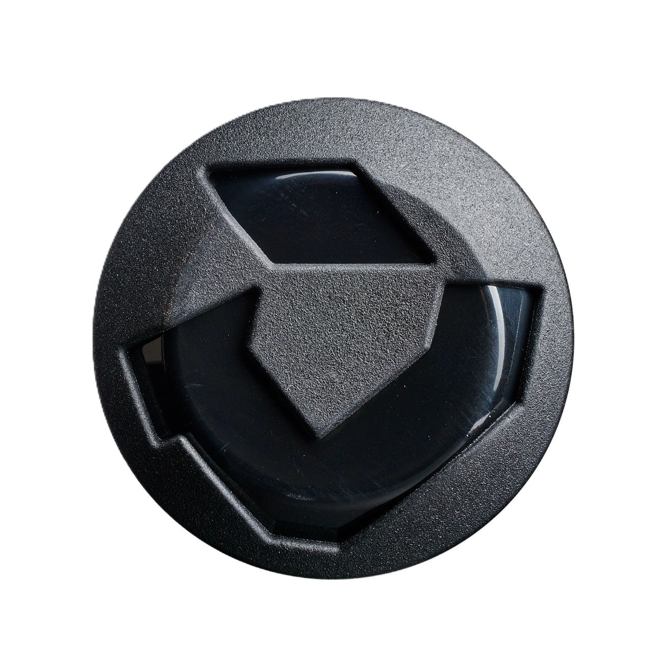 A round black camera lens cap with geometric cutouts, viewed from above on white, features a design reminiscent of the precise midload barrel of the DeMarini 2027 Caligold 13" Senior Slowpitch Softball Bat (WBD2738010).