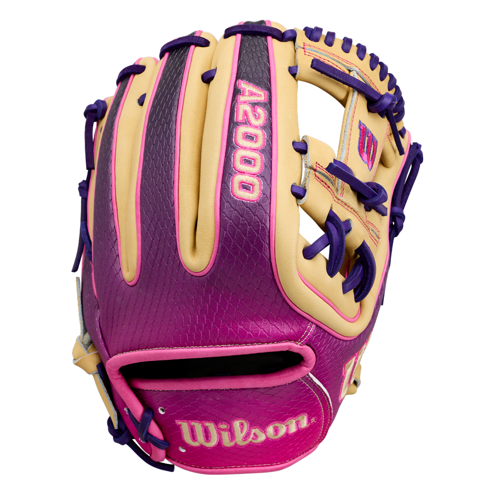 The Wilson A2000 1720SS 11.5″ Baseball Glove: WBG0009401RT115 by Wilson showcases a stylish blend of tan, purple, and pink, highlighted by bold purple laces. With vibrant pink “A2000” lettering on the back and “Wilson” on the wrist strap, this infielders glove is ideal for players who want both standout style and top-tier performance.