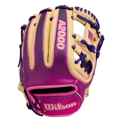 The Wilson A2000 1720SS 11.5″ Baseball Glove: WBG0009401RT115 by Wilson showcases a stylish blend of tan, purple, and pink, highlighted by bold purple laces. With vibrant pink “A2000” lettering on the back and “Wilson” on the wrist strap, this infielders glove is ideal for players who want both standout style and top-tier performance.