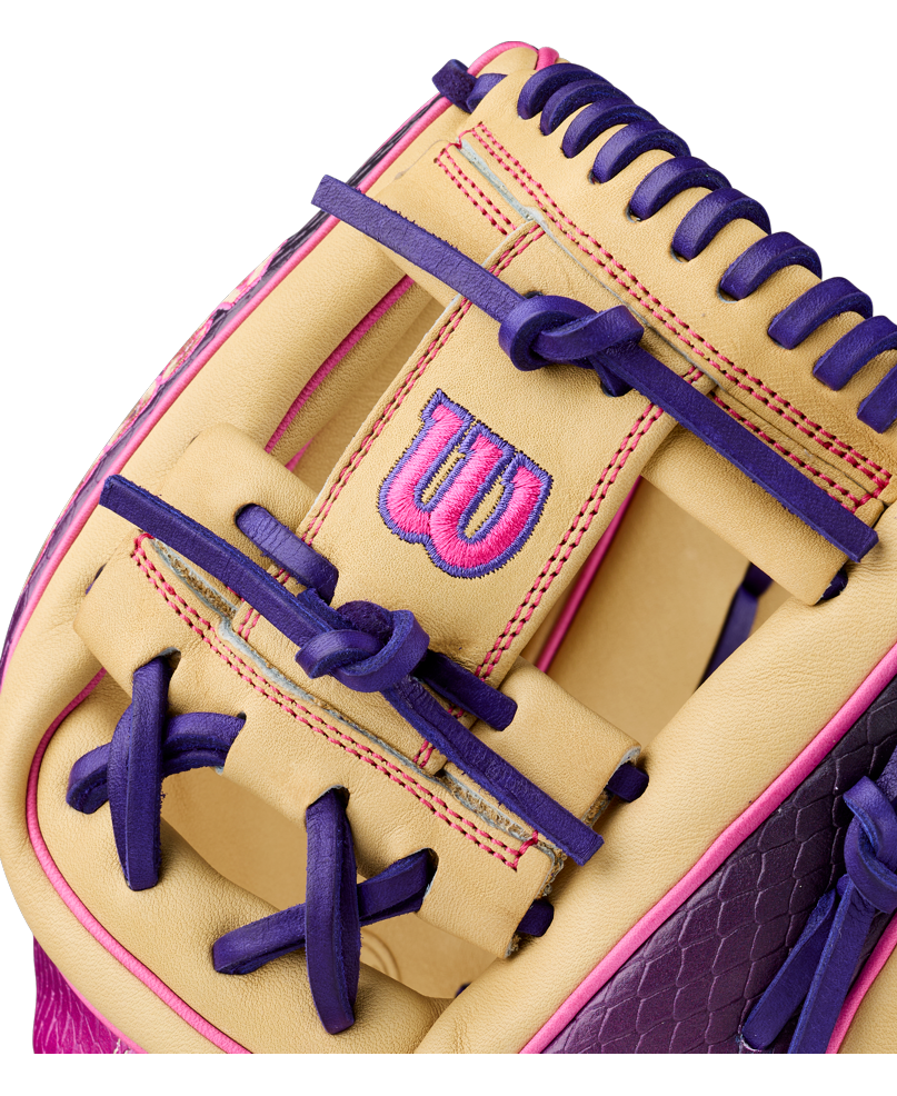 Close-up of the Wilson A2000 1720SS 11.5″ Baseball Glove (WBG0009401RT115) in beige, highlighted with vibrant purple and pink laces, and featuring a pink and purple embroidered Wilson “W” logo.