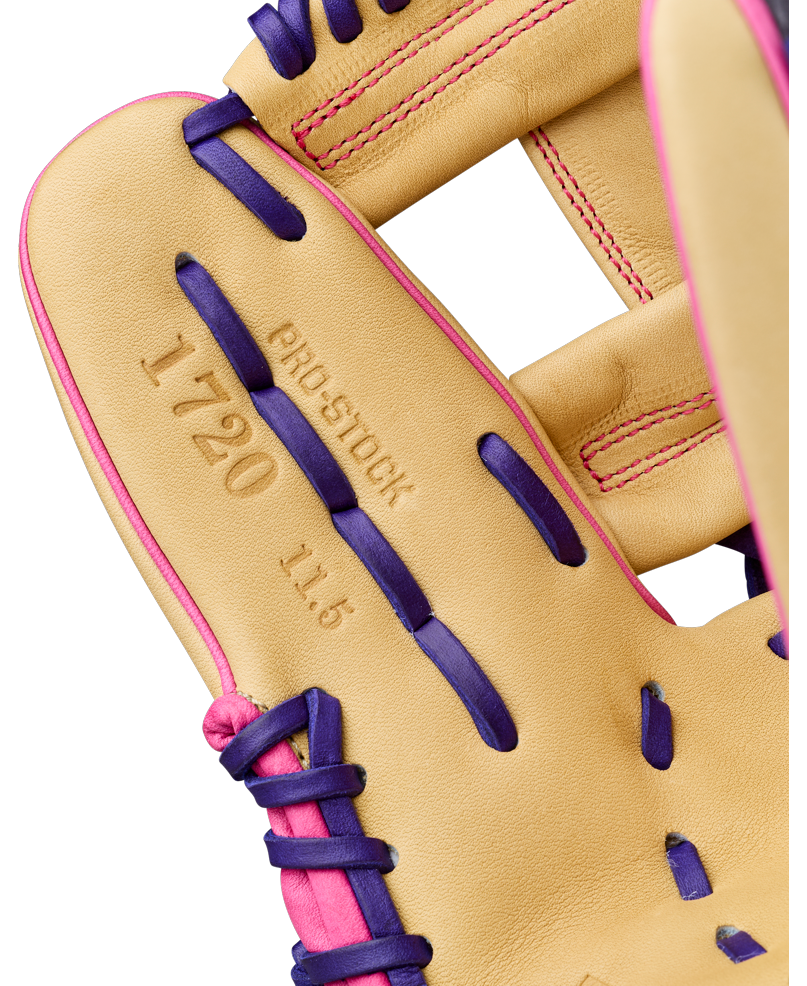 Close-up of a tan Wilson A2000 1720SS 11.5″ Baseball Glove: WBG0009401RT115, accented with purple laces and pink stitching, highlighting the embossed text “1720 PRO STOCK 11.5” on the leather—a premium infield glove from Wilson engineered for precise fielding.