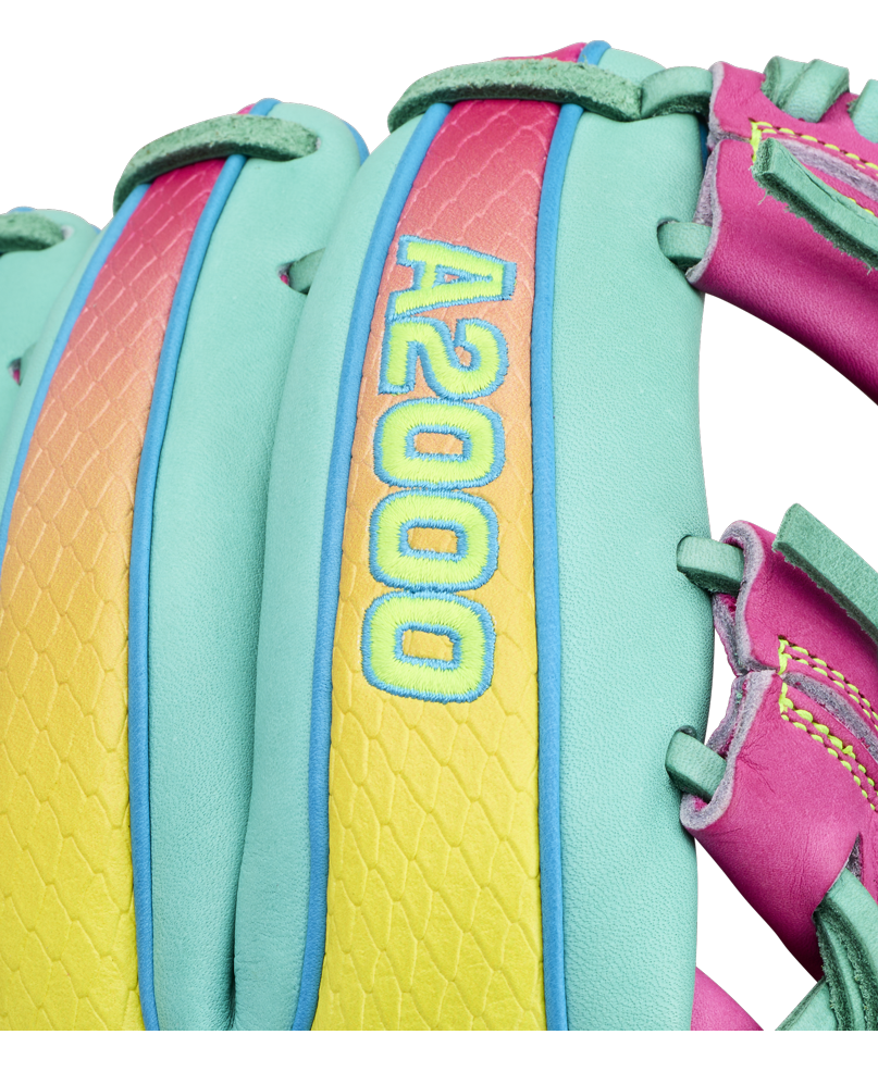 Close-up of a colorful Wilson A2000 1727SS 11.5″ Baseball Glove (WBG0009501RT1175) with “A2000 1727SS” embroidered in yellow and blue on a vibrant pink, yellow, and teal background. This Wilson glove features SuperSnakeSkin material, complemented by teal, pink, and green stitching and laces.