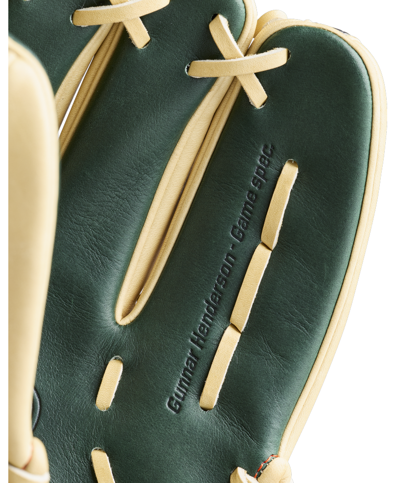 A close-up of the Wilson A2000 GH2 11.75″ Gunnar Henderson GM Baseball Glove (WBG0009601RT1175) by Wilson, featuring a dark green and tan colorway with “Gunnar Henderson. Game spec.” embossed on one finger, showcases this premium infield glove inspired by the renowned A2000 series.