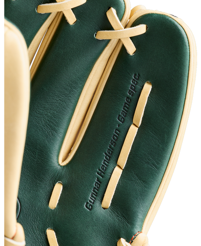 A close-up of the Wilson A2000 GH2 11.75″ Gunnar Henderson GM Baseball Glove (WBG0009601RT1175) by Wilson, featuring a dark green and tan colorway with “Gunnar Henderson. Game spec.” embossed on one finger, showcases this premium infield glove inspired by the renowned A2000 series.
