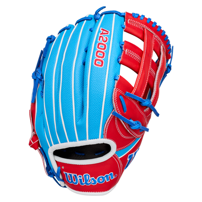 A Wilson A2000 PCA4 12.5″ Pete Crow-Armstrong GM Baseball Glove (WBG0009701) is displayed on a plain white background, featuring a blue and red design with white pinstripes, blue lacing, and the Wilson logo on the wrist strap. This glove is inspired by Pete Crow-Armstrong’s signature model.