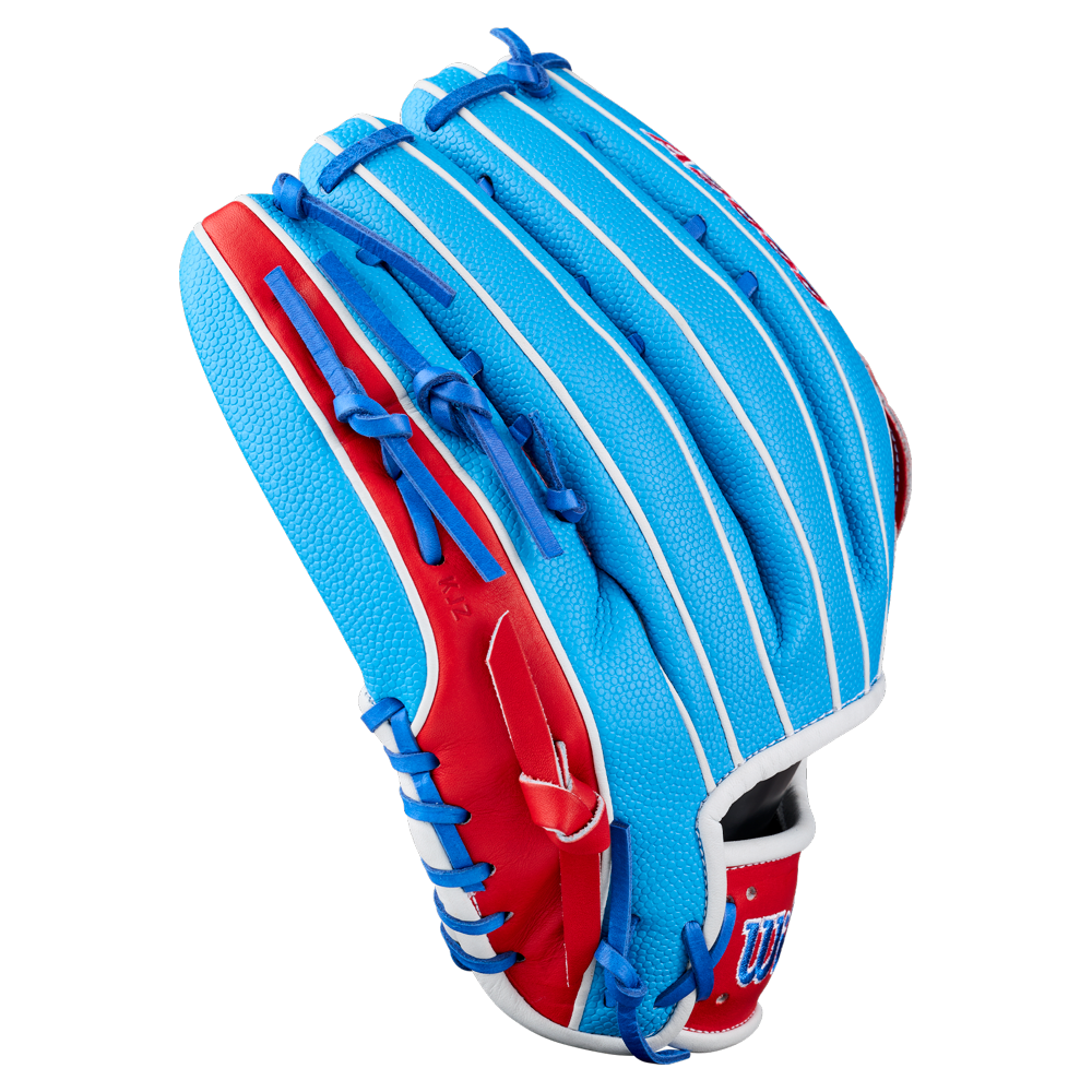 A Wilson A2000 PCA4 12.5″ Pete Crow-Armstrong GM Baseball Glove (WBG0009701) in blue with red and white accents, blue laces, and textured leather is displayed from the back on a plain white background—an ideal outfield glove designed in collaboration with Pete Crow-Armstrong for the Wilson A2000 series.