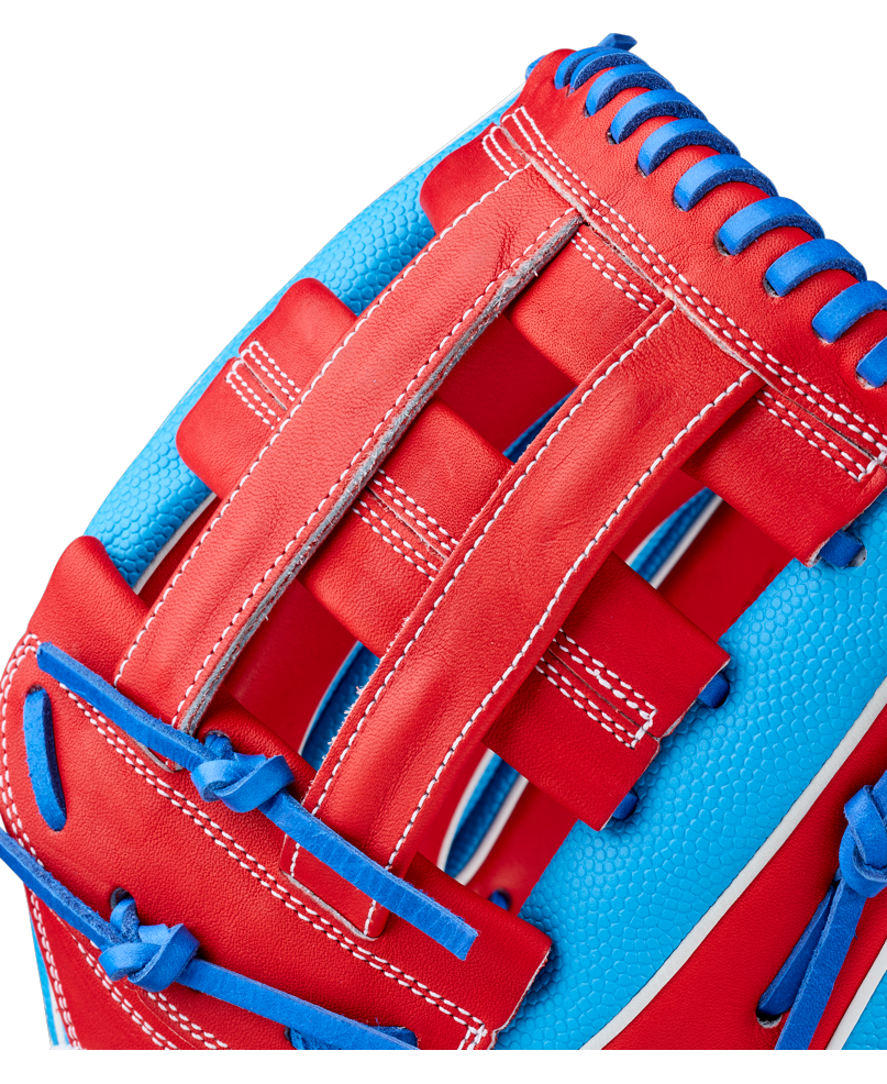 Close-up of the Wilson A2000 PCA4 12.5″ Pete Crow-Armstrong GM Baseball Glove (WBG0009701) by Wilson, highlighting the detailed stitching, durable leather texture, and blue lacing along the edges, all in vibrant colors inspired by Pete Crow-Armstrong’s game model design.