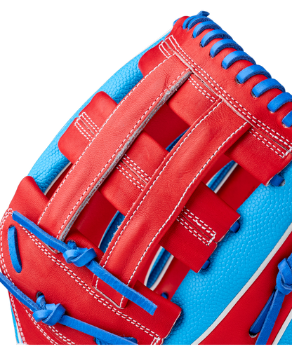 Close-up of the Wilson A2000 PCA4 12.5″ Pete Crow-Armstrong GM Baseball Glove (WBG0009701) by Wilson, highlighting the detailed stitching, durable leather texture, and blue lacing along the edges, all in vibrant colors inspired by Pete Crow-Armstrong’s game model design.