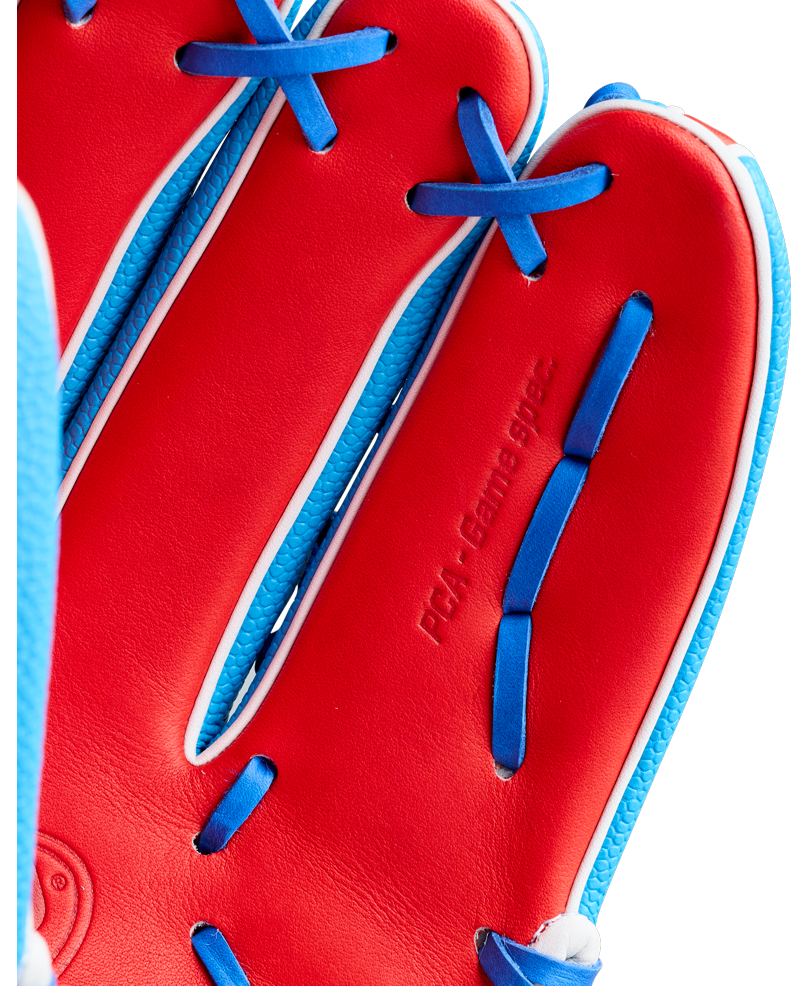 Close-up of a red Wilson A2000 PCA4 12.5″ Pete Crow-Armstrong GM Baseball Glove (WBG0009701), featuring blue laces and white trim, with “PGR Gaming spec.” embossed on the palm, reminiscent of the signature style used by Pete Crow-Armstrong.