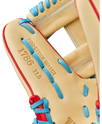Close-up of a Wilson A2K 1786 11.5″ Baseball Glove (WBG0010101RT115), featuring tan Pro Stock Select leather accented with red and blue laces. The infield glove showcases gold stamping of PRO-STOCK SELECT, 1786, and 11.5 on the inside palm area.