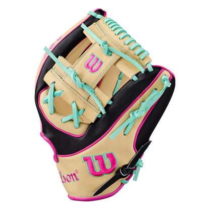 A Wilson A2K 1724 11.75″ Baseball Glove (WBG0010201RT1175) in tan, black, and pink—with teal laces, logo, and stitching accents—designed for infielders and built with Double Palm Construction from the Wilson brand is displayed from the side on a white background.