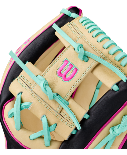 Close-up of the Wilson A2K 1724 11.75″ Baseball Glove (WBG0010201RT1175) by Wilson, showcasing its cream, black, teal, and pink accents—including teal laces and a pink W logo on premium cream leather. Engineered as an infielder’s glove with Double Palm Construction to enhance durability and maintain its shape.