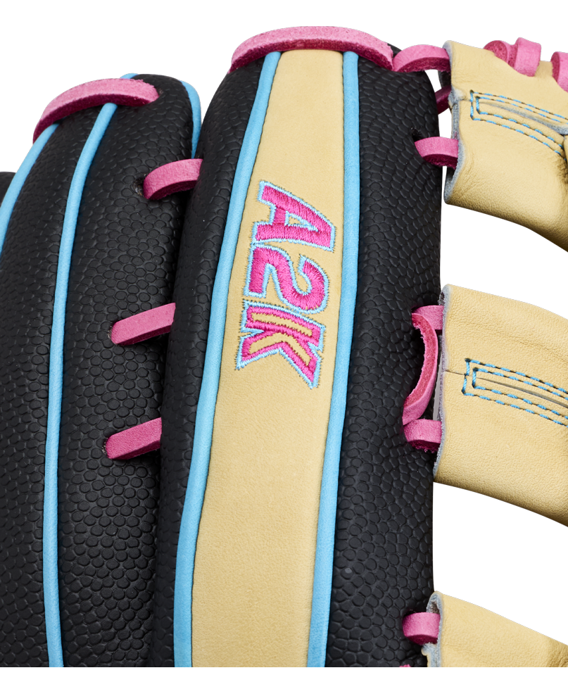 Close-up of the Wilson A2K 1777 12.75″ Baseball Glove (WBG0010301) by Wilson, featuring black textured leather, tan laces, and blue and pink stitching. This outfield glove offers Double Palm Construction for improved pocket stability, with “A2K” embroidered in pink and blue on a tan leather strip.