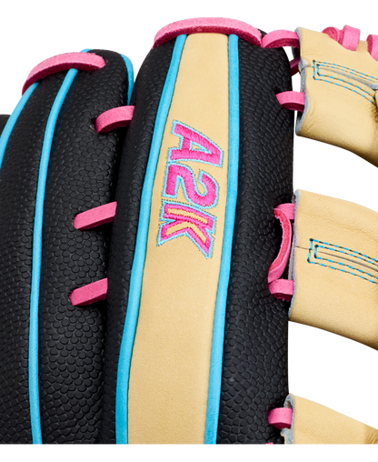 Close-up of the Wilson A2K 1777 12.75″ Baseball Glove (WBG0010301) by Wilson, featuring black textured leather, tan laces, and blue and pink stitching. This outfield glove offers Double Palm Construction for improved pocket stability, with “A2K” embroidered in pink and blue on a tan leather strip.
