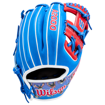 The Wilson A2000 1786SS 11.5" Baseball Glove (GOTM July 2026) features Pro Stock leather in blue, red, and white with decorative lower palm patterns and bold red lacing.
