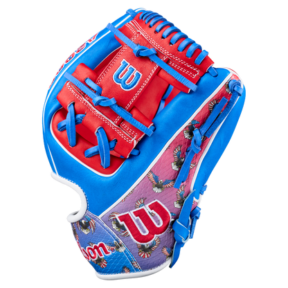 The Wilson A2000 1786SS 11.5" Baseball Glove (GOTM July 2026) features bright blue, red, and purple accents, Pro Stock leather, the Wilson logo, and an eagle pattern on the purple section near the wrist.