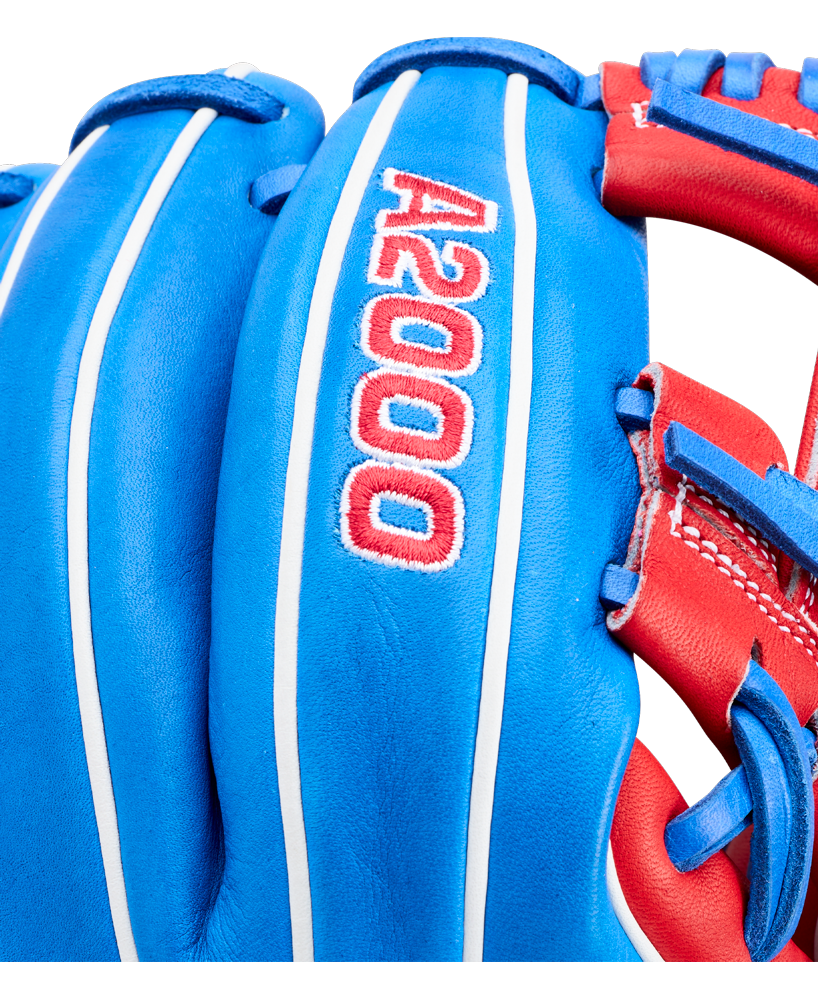 Close-up of the Wilson A2000 1786SS 11.5" Baseball Glove (GOTM July 2026), crafted with Pro Stock leather in blue with red and white accents, featuring detailed stitching and "A2000" embroidered on the back.