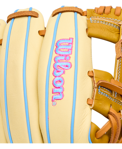 Wilson A1000 1786 11.5″ Baseball Glove in tan with light blue piping and pink and blue embroidered lettering on the palm.