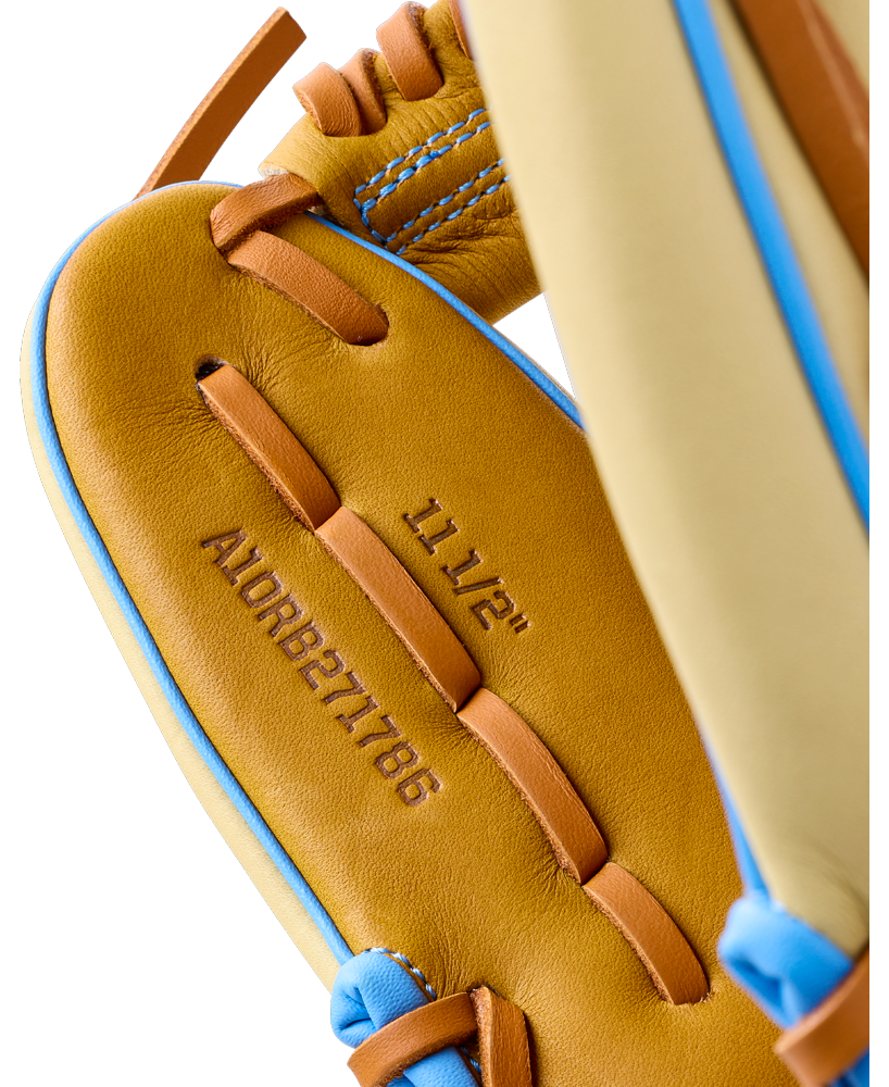 Close-up of the interior palm of an 11.5″ Wilson A1000 1786 11.5″ Baseball Glove: WBG02501RT1786, showing stamped model information and lacing details.