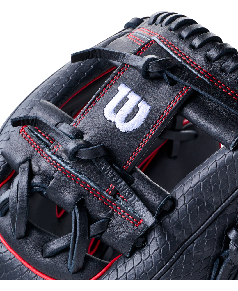 Close-up of a black Wilson A1000 1975SS 11.75″ Baseball Glove featuring red stitching and a textured leather pattern.