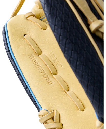 Close-up of a yellow and black Wilson A1000 1750 12.5″ Baseball Glove, showing the embossed text 12 1/2 and A10RB271750 on the inner palm.