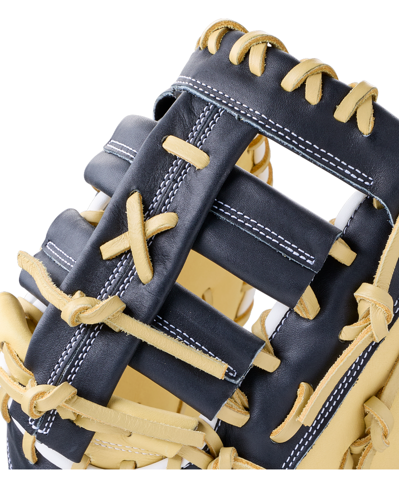 Close-up of a 12″ navy blue Wilson A1000 PF1612 12″ Baseball First Base Mitt with tan full grain leather lacing.