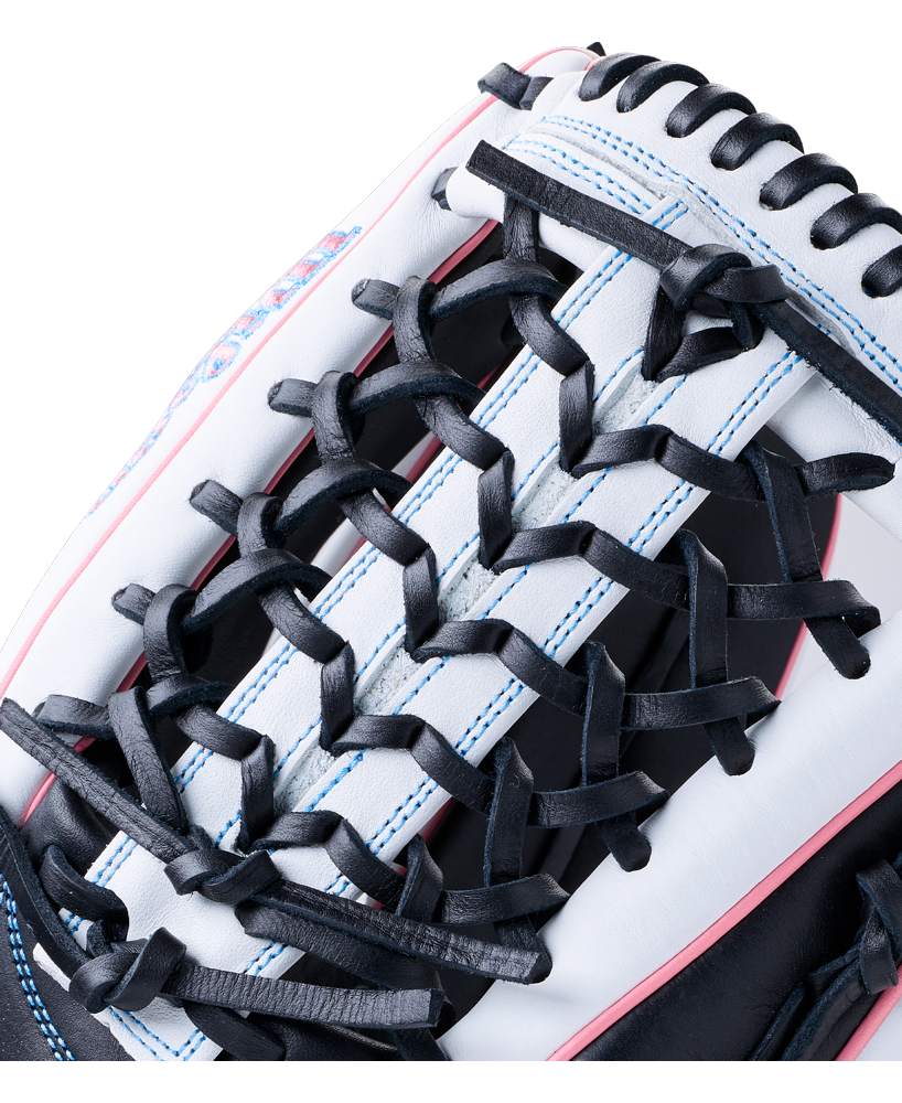 Close-up of a white and black Wilson A1000 T125 12.5″ Fastpitch Glove: WBG03501RTT125 with blue stitching and pink piping.
