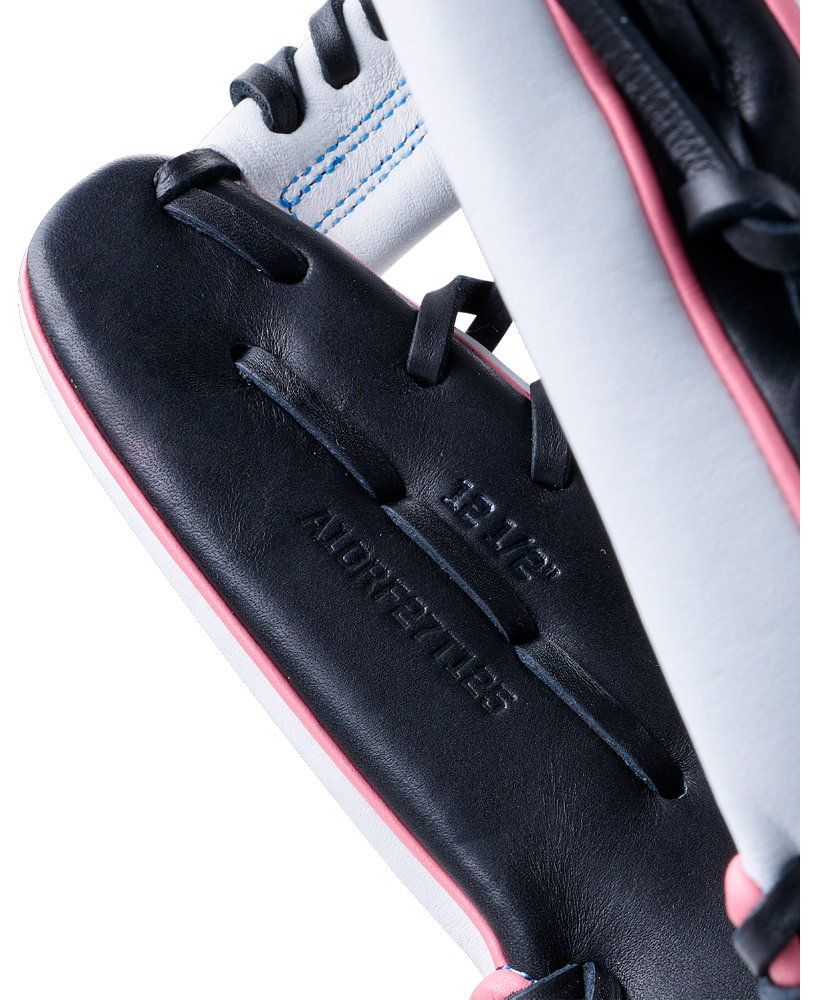 Close-up of a black and white Wilson A1000 T125 12.5″ Fastpitch Glove with pink piping, showing the 12.5-inch size stamp on the palm.