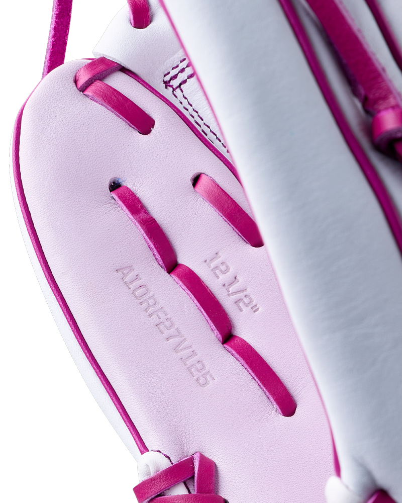 Close-up of a white and pink Wilson A1000 V125 12.5″ Fastpitch Glove, showing the 12 1/2 inch size and model number embossed on the palm.