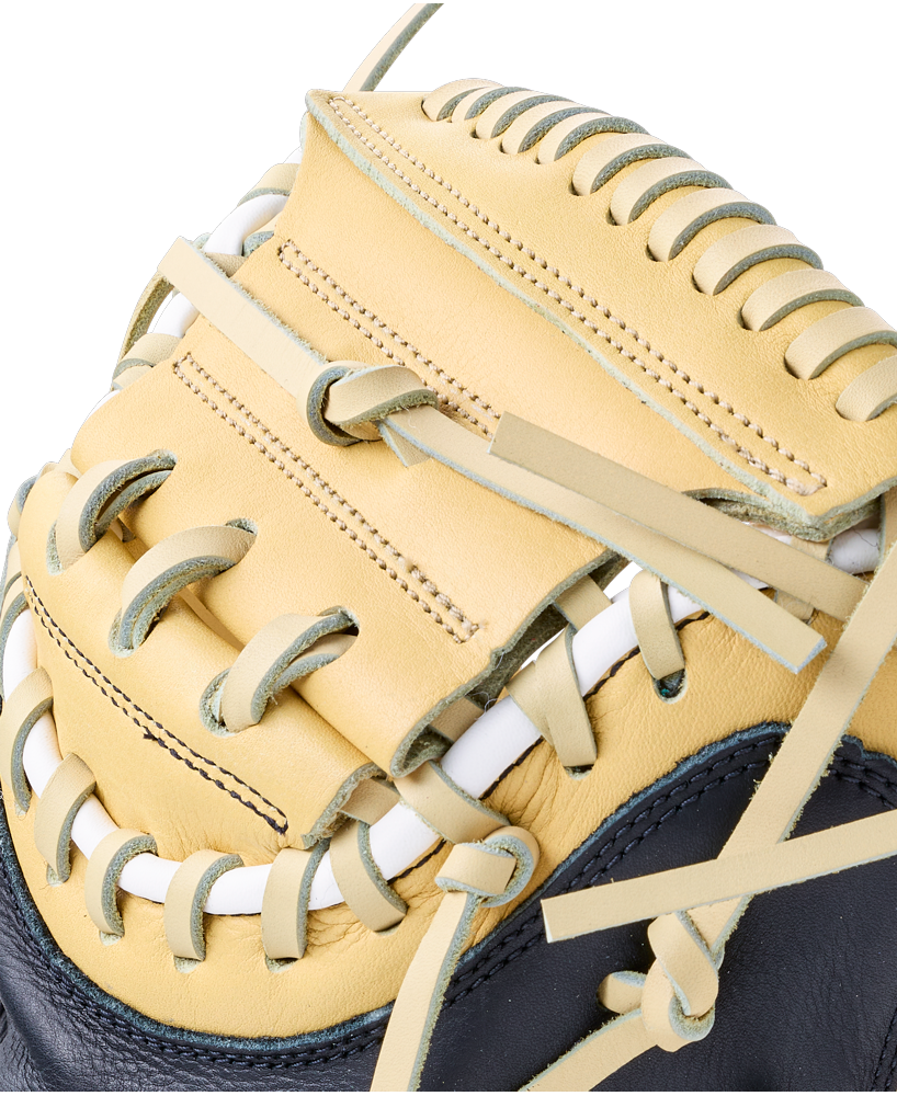 Close-up of a tan and black Wilson A700 32.5″ Baseball Catcher’s Mitt: WBG04701RT325 made from full grain leather, featuring white lacing.