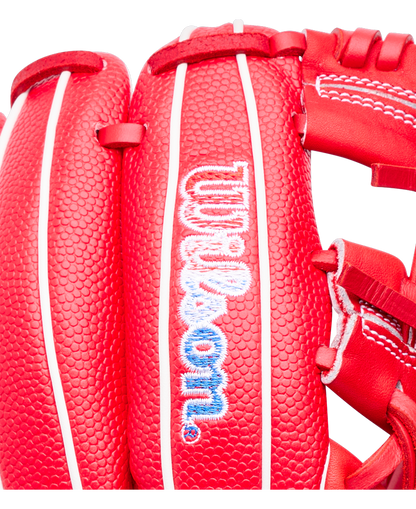 Close-up of a bright red Wilson A1000 PF11SS 11″ Baseball Glove with white piping and the manufacturer’s logo embroidered in blue and white on the wrist strap.