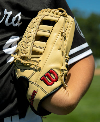 A tan Wilson A1000 1892 12.25″ Baseball Glove: WBG05301RT1225 worn on a player’s hand.