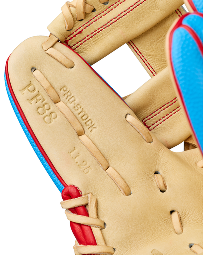 Close-up of a Wilson A2000 PF88SS 11.25″ baseball glove in tan leather, featuring red stitching, blue trim, and PRO STOCK, PF88, and 11.25 embossed on the palm. This Wilson glove (WBG05402RT1125) incorporates Pedroia Fit Technology for enhanced feel and superior control.
