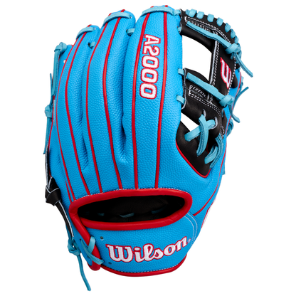 A Wilson A2000 1786SS 11.5″ baseball glove (WBG05601RT115) in blue with red accents and black lacing, featuring the Wilson brand name and model stitched in white. This glove is engineered for quick transfers and exceptional control on the field.