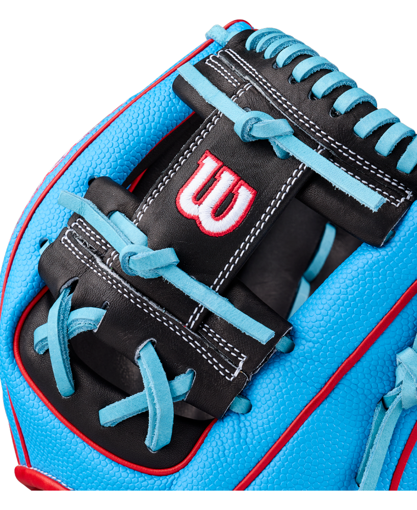 Close-up of the Wilson A2000 1786SS 11.5″ Baseball Glove (WBG05601RT115), featuring premium blue and black leather with light blue laces, red accents, and a white and red Wilson “W” logo stitched on the black leather. This glove showcases expert craftsmanship for serious players.
