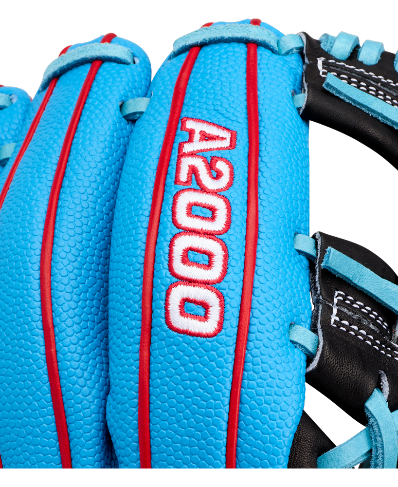 Close-up of a bright blue Wilson A2000 1786SS 11.5″ baseball glove (WBG05601RT115) with red stitching and white embroidered “A2000” text. The glove also features black sections, white laces, and is crafted by Wilson.