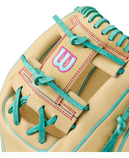Close-up of the Wilson A2000 1975 11.75″ Baseball Glove (WBG05701RT1175) in tan, featuring teal laces, pink stitching, a prominent Wilson “W” logo on the strap, and an extra deep pocket.