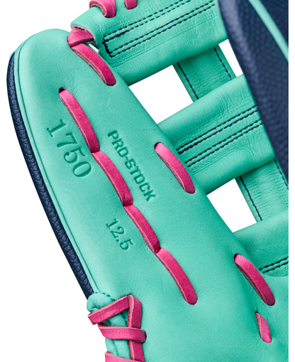 Close-up of the Wilson A2000 1750SS 12.5″ Baseball Glove by Wilson, featuring a turquoise color with pink laces and displaying the text “1750,” “PRO STOCK,” and “12.5” on the inside.