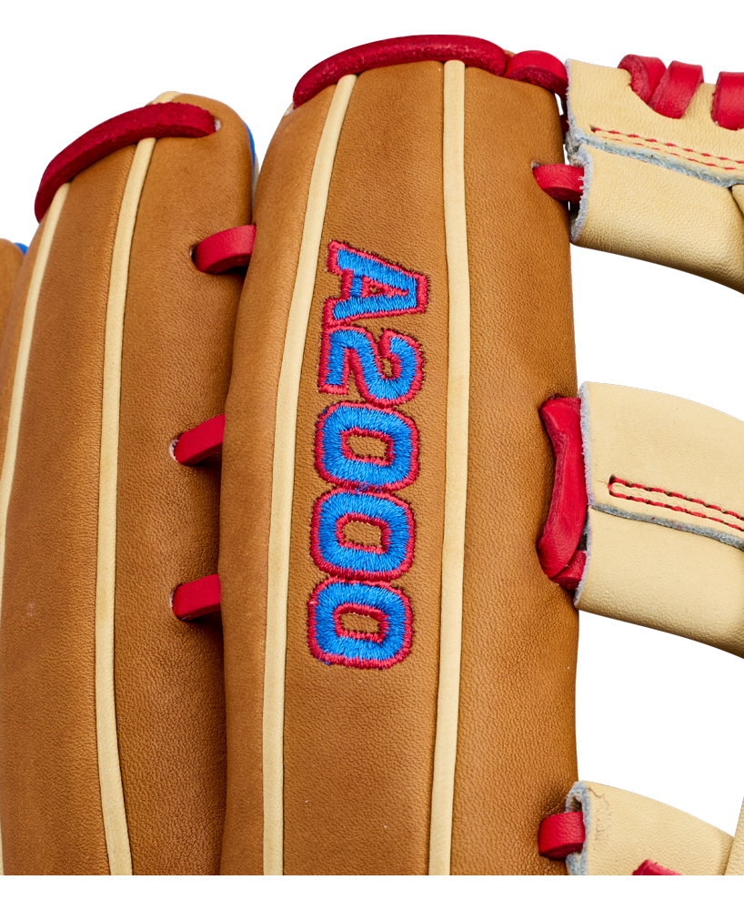 Close-up of a brown Wilson A2000 1777 12.75″ Baseball Glove: WBG06001RT1275 with red lacing and blue embroidery that reads “A2000” on the back. Crafted from durable Pro Stock leather, this Wilson outfield baseball glove offers both reliability and standout style.